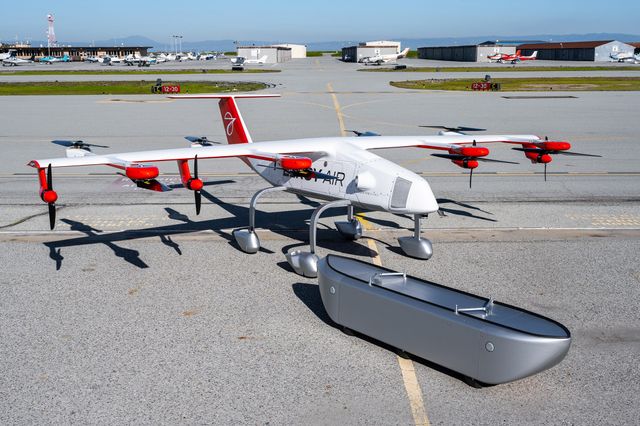 The Chaparral ground test vehicle aircraft and its flight cargo pod parked outside their hangar at Byron Airport.